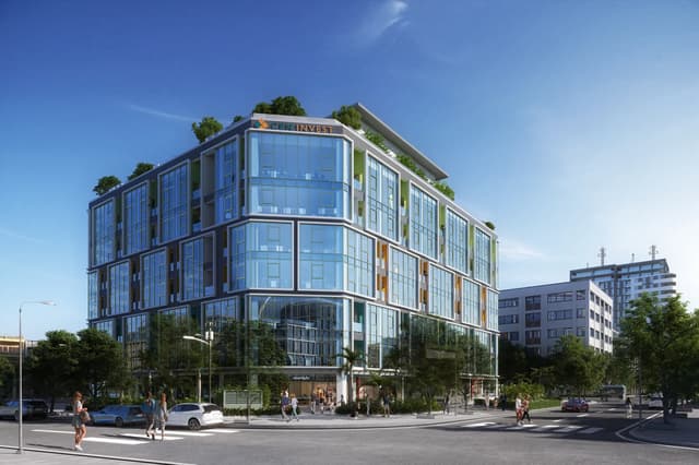 Mặt đứng tòa nhà văn phòng nhìn từ góc giao lộ vào ban ngày — Plaschem Building, Hà Nội